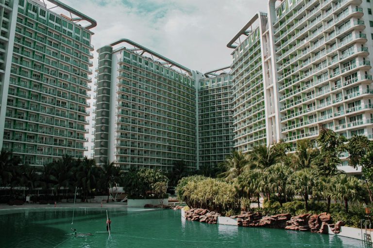 Investing in Guinea Hotels Tourism Growth and Hospitality Real Estate - YES! INVEST in GUINEA A modern 5-star hotel tower overlooking the Conakry shoreline, a prime example of the growth fostered by Yes! Invest in Guinea.