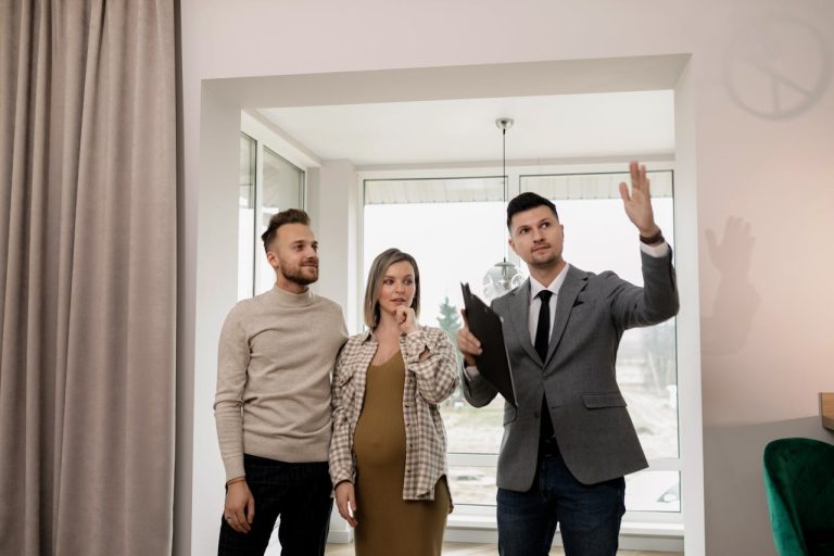 Real Estate Boom in Guinea 2026 Urban Development and Property Opportunities - YES! INVEST in GUINEA A professional real estate agent showing a modern apartment interior to international clients, illustrating the personalized service at Yes! Invest Guinea.